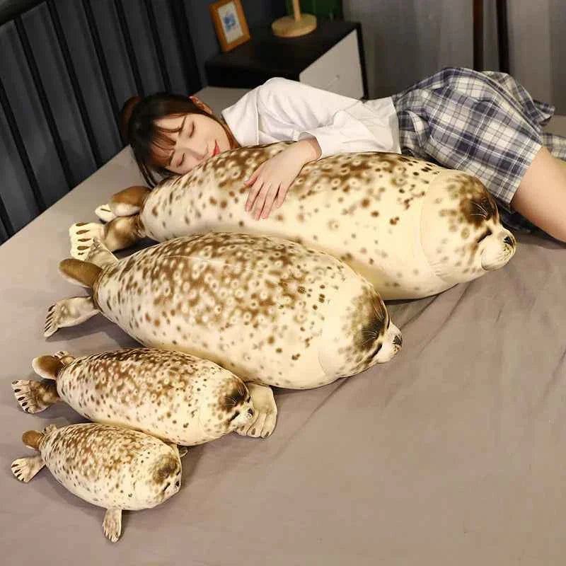 A giant 120cm lifelike spotted seal plush toy with realistic grey spots and flippers, resting comfortably on a soft blue rug.