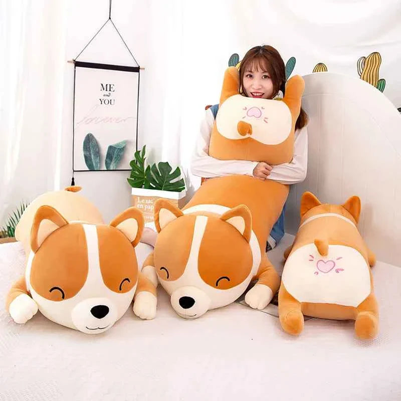 A giant 120cm Shiba Inu plush toy in a lying position on a bed, showing its soft orange and white fur and adorable sleeping face.