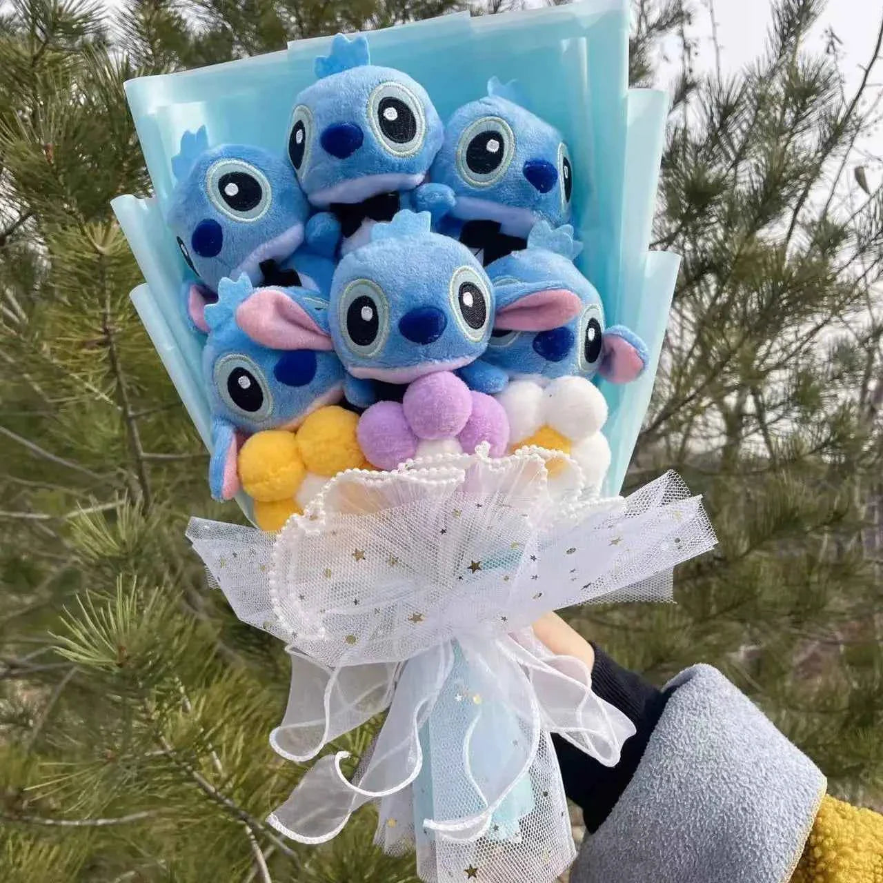 A handcrafted Stitch plush bouquet featuring the blue alien character surrounded by premium artificial roses, wrapped in aesthetic decorative gift paper.