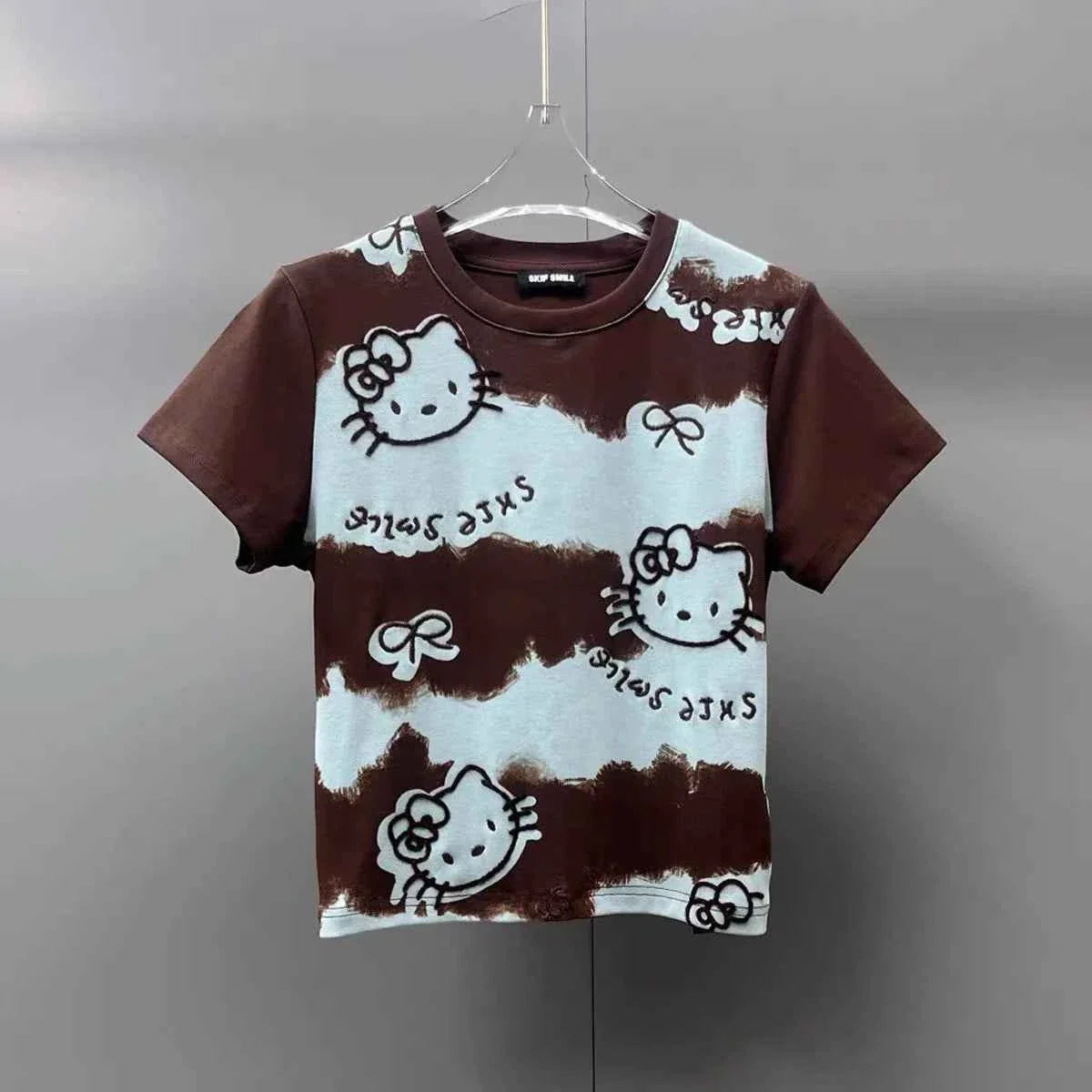 A collection of premium apparel including high-quality graphic t-shirts and heavyweight hoodies hanging on a sleek clothing rack in a modern fashion studio.