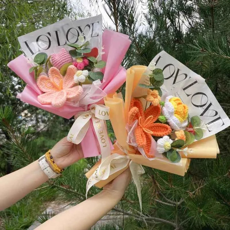 A beautiful handmade crochet flower bouquet featuring pink roses and yellow sunflowers made from soft wool, wrapped in premium paper for a graduation gift.