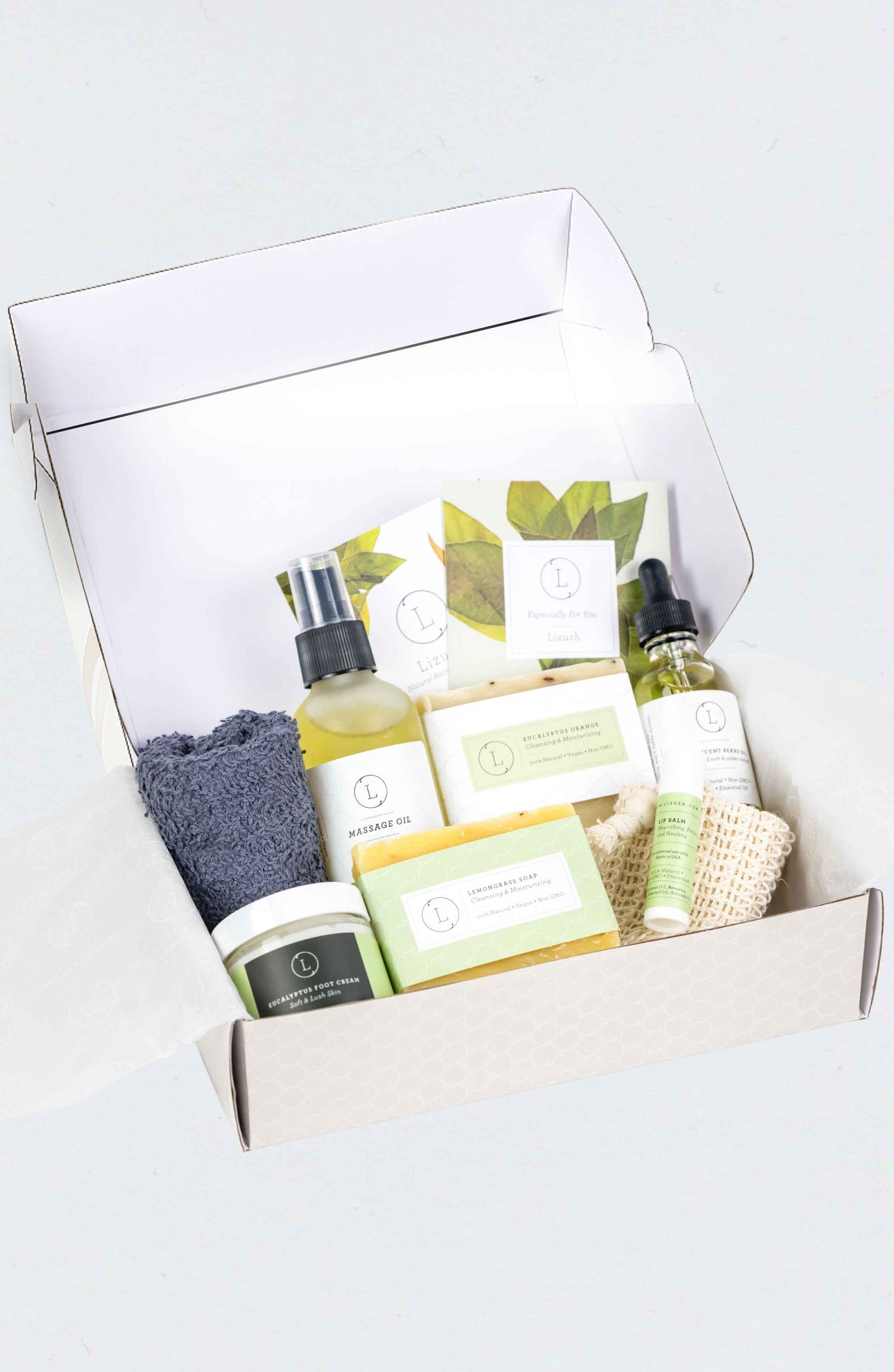 Premium Father's Day grooming gift box featuring Eucalyptus soap, glass massage oil bottle, beard oil, and personalized name lettering on the lid.