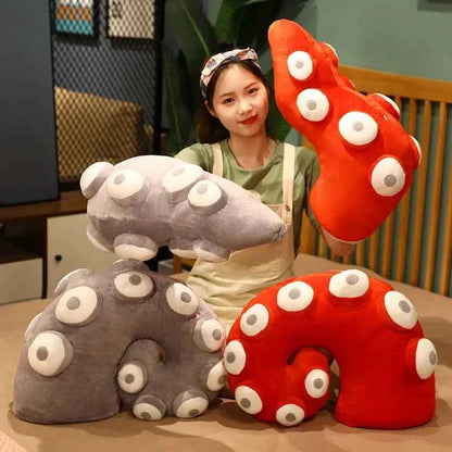 Person holding colorful U-shaped pillow toys with a neutral background