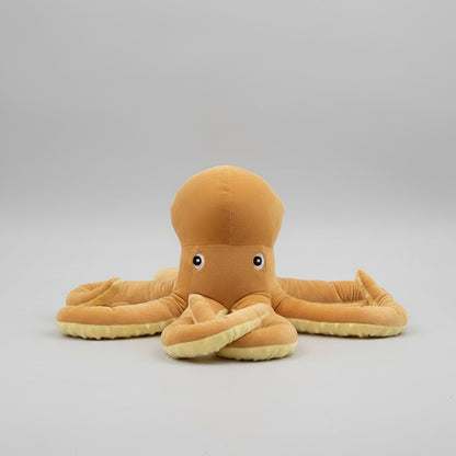Plush octopus toy on a round table in a living room setting