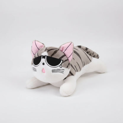 Plush toy cat with sunglasses on a wooden floor