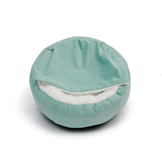 Round teal pillow with a white interior on a white background
